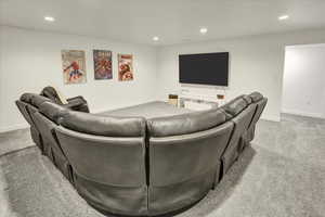 Living room with recessed lighting and light colored carpet