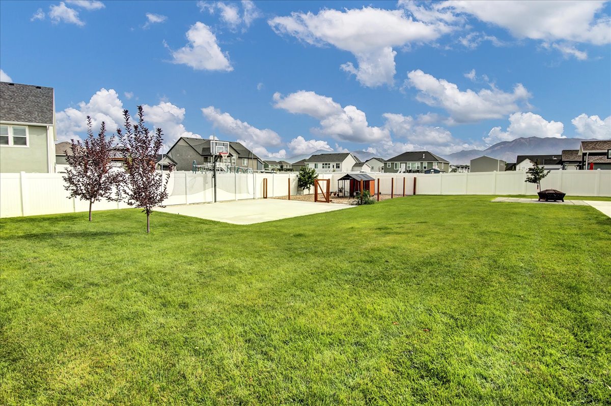 Fenced backyard with a residential view