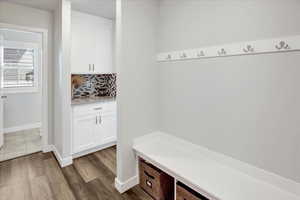 Mudroom featuring baseboards and dark wood finished floors