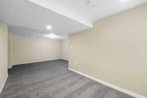 Finished below grade area with carpet flooring and recessed lighting