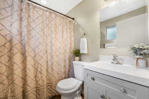 Full bath with vanity and curtained shower