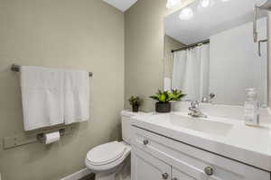 Full bathroom featuring vanity and curtained shower