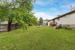 View of yard with an outdoor fire pit