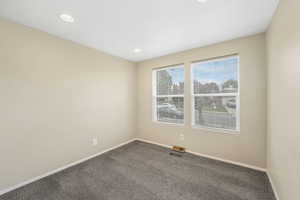 Carpeted spare room featuring recessed lighting and baseboards