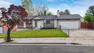 Single story home featuring concrete driveway, a chimney, a garage, and roof with shingles