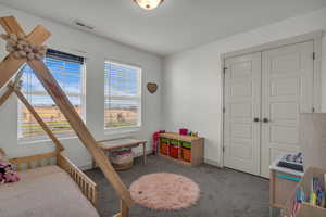 Bedroom with carpet floors and a closet