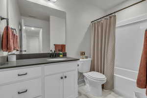 Bathroom with shower / tub combo and vanity