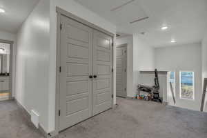 Hallway featuring recessed lighting, carpet, and attic access