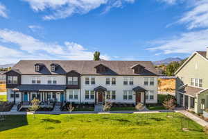 View of front facade featuring a mountain view, a front lawn, and covered porch