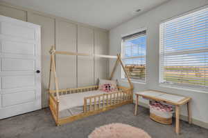 Carpeted bedroom with baseboards