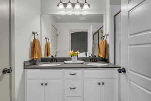 Bathroom with double vanity and a shower stall