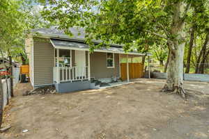Back of house with roof with shingles and a patio