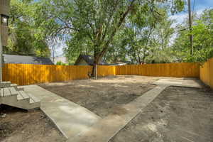 Fenced backyard with a patio area