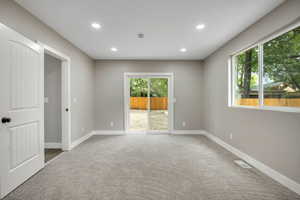 Spare room with light carpet and recessed lighting