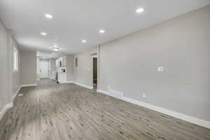 Unfurnished living room with light wood-type flooring and recessed lighting