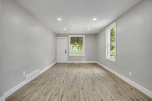 Spare room featuring light wood-style floors and recessed lighting