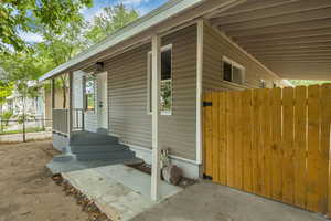 View of side of home featuring a gate