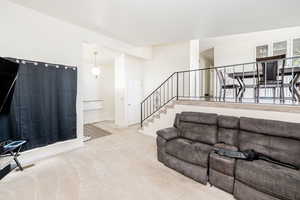 Carpeted living area with baseboards