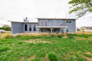 Rear view of property with a chimney and a deck