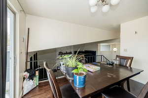 Dining area with dark wood-style floors
