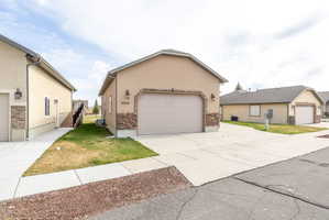 Single story home with stucco siding and a front yard