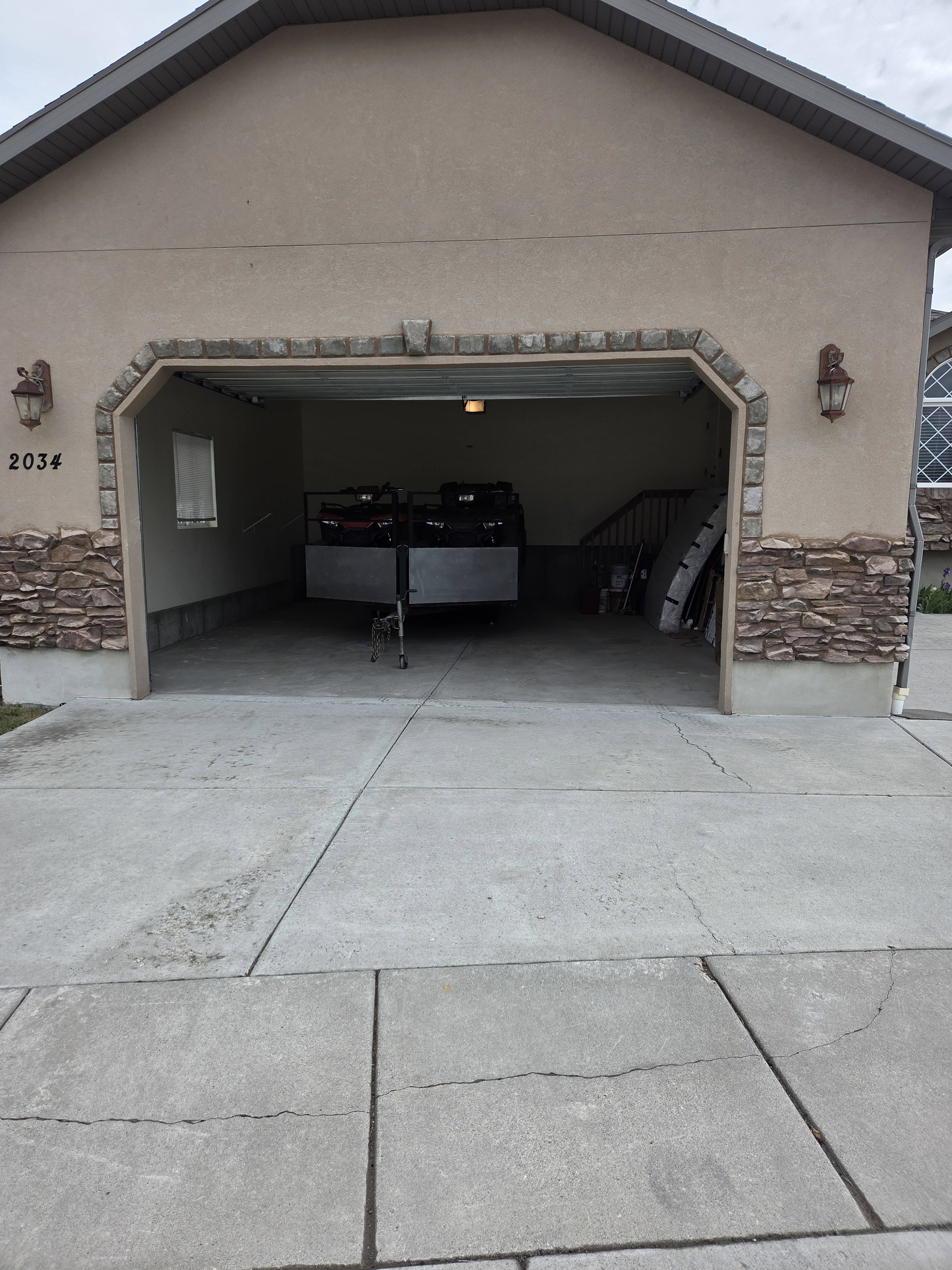 Integrated two-car garage with a concrete driveway