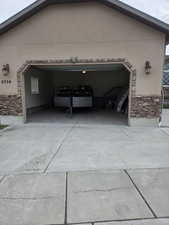 Integrated two-car garage with a concrete driveway