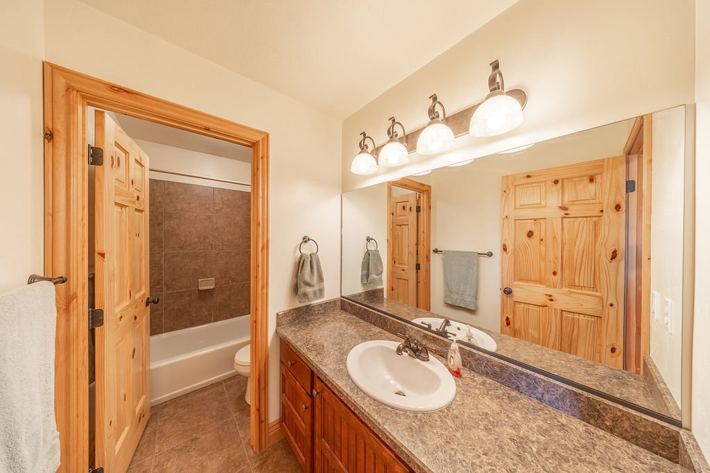 Bathroom featuring vanity, light tile patterned floors, and bathtub / shower combination