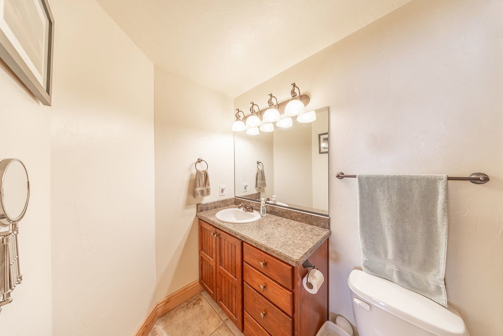 Half bathroom with vanity and light tile patterned floors