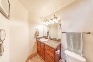Half bathroom with vanity and light tile patterned floors