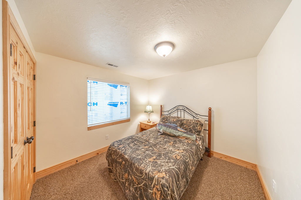 Bedroom featuring a textured ceiling and carpet