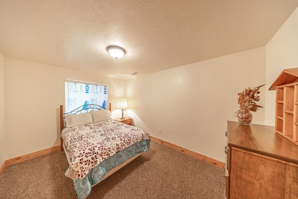 Bedroom featuring a textured ceiling and carpet