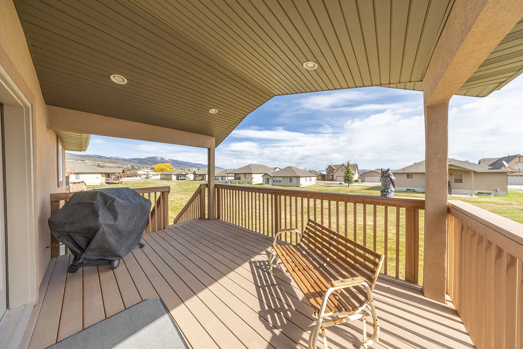 Deck featuring a residential view, a lawn, and area for grilling