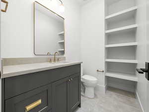 Bathroom with vanity and a closet