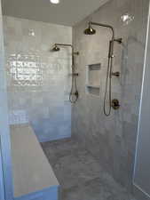 Full bath featuring a tile shower