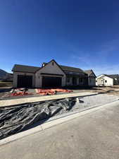 View of front of house with a garage and driveway