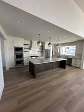 Kitchen with open shelves, light countertops, backsplash, a kitchen island, and two tone color scheme