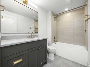 Bathroom with vanity, shower / washtub combination, light tile patterned floors, and recessed lighting