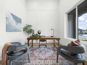 Office space with a decorative wall and wood finished floors