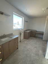 Bathroom featuring two vanities and recessed lighting