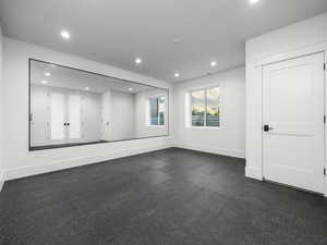 Spare room with baseboards and recessed lighting
