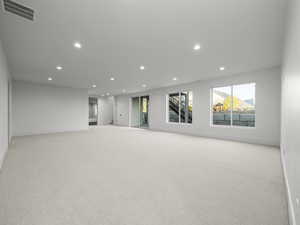 Spare room featuring recessed lighting and light colored carpet