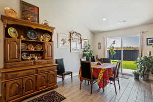 Dining room with wood tiled floors and recessed lighting