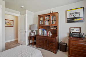 Bedroom featuring light colored carpet