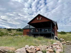 Back of house featuring a deck