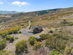 Aerial view of property and surrounding area with a mountainous background