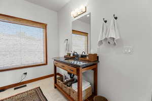 Bathroom featuring light tile patterned floors and plenty of natural light