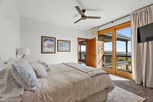 Bedroom featuring access to exterior, carpet flooring, and a ceiling fan