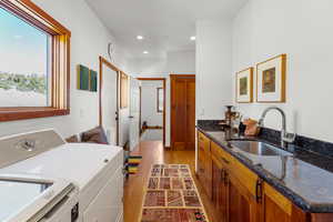 Washroom featuring light wood-style floors, recessed lighting, and washer and dryer