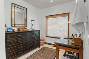 Office with light tile patterned floors and recessed lighting